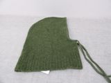 a green knitted hat on a white surface