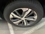 a close up of a tire on a car in a parking lot