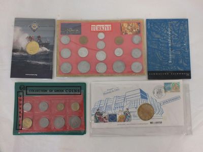 four books and a coin are sitting on a white surface