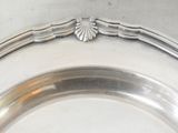 a silver plate with a decorative design on it