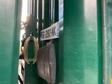 a close up of a green train car with a sign on it