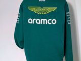 a close up of a green sweatshirt with the name of the team on it