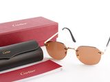 cartier sunglasses with box and case on a white surface