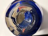 a close up of a blue glass with a clock on it