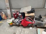 a pile of junk on a pallet next to a garage door
