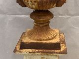 a vase that is sitting on a pedestal on a table