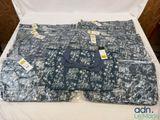a close up of a bed with a lot of clothes on it