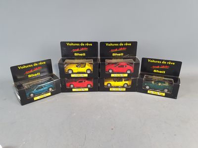 six different models of toy cars in boxes on a table