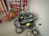 a vacuum that is sitting on the floor next to the stairs