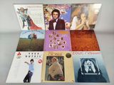 various album covers of various albums on display on a table