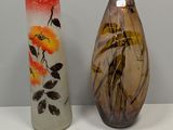 two vases that are sitting on a table