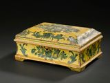 yellow and green painted box with flowers and vines on it