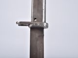 a close up of a knife on a white surface