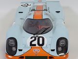 a blue and orange race car on a white surface