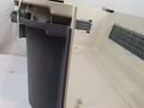 a close up of a dog laying in a kennel with its door open