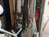 a pile of skis and other equipment in a garage