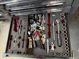 a drawer full of tools that are sitting on the floor