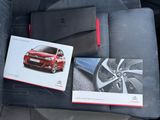 a picture of a red car and a book in the back seat of a car