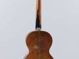 a close up of a wooden guitar on a white background