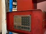 a red telephone that is attached to the side of a building