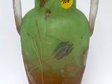 a glass vase with a green and brown design on it