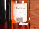 a bottle of wine sitting on a table next to a wooden box