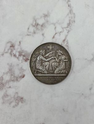 a close up of a silver coin on a marble surface