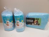 two bags of toilet paper and a bag of toilet paper on a table