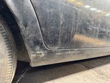 a close up of a dirty car tire on the street