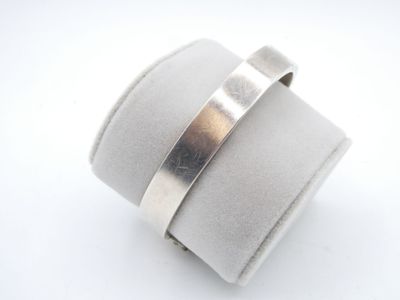 sterling silver ring with a thin band on top of a ring holder