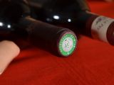 two bottles of wine sitting on a red table