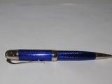 a blue pen sitting on top of a white table