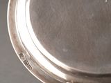 a close up of a silver plate on a table