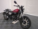 a red motorcycle that is parked in a garage
