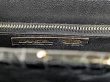 a close up of a black purse with a gold zipper