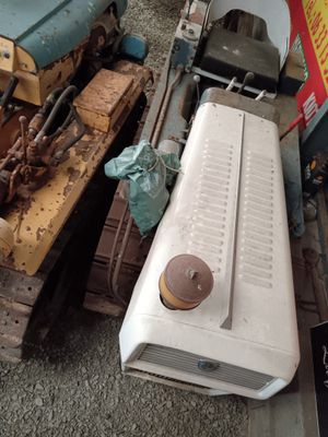 a white refrigerator and a blue and yellow refrigerator next to each other