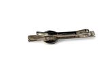 silver tie bar with a black button on a white background