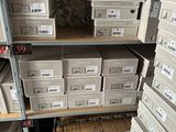 a lot of boxes that are stacked on the shelves