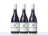 three bottles of wine sitting on top of a table