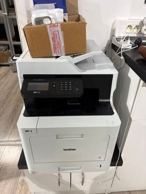 a printer that is sitting on top of a stack of boxes