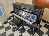 a piano in the corner of a room with a checkered floor