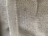 the back of a sweater with a small hole in the middle of it