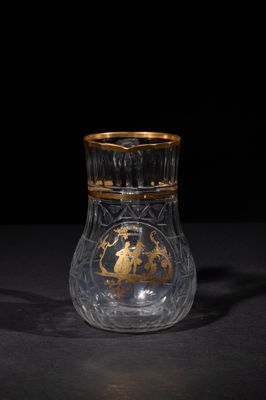 a close up of a glass vase on a table with a black background