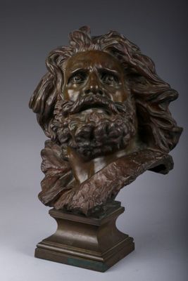 a bronze bust of a bearded man with long hair and a beard