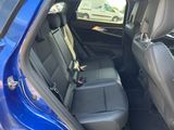 the back seats of a blue car in a parking lot