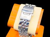 a watch that is sitting on top of a wooden stand