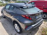 the rear end of a gray toyota c - hr parked in a parking lot