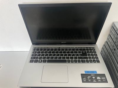 an open laptop computer sitting on top of a desk next to a stack of books