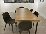 a table and chairs in a room with a large window
