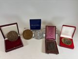 four medals and a medal are sitting on a white surface